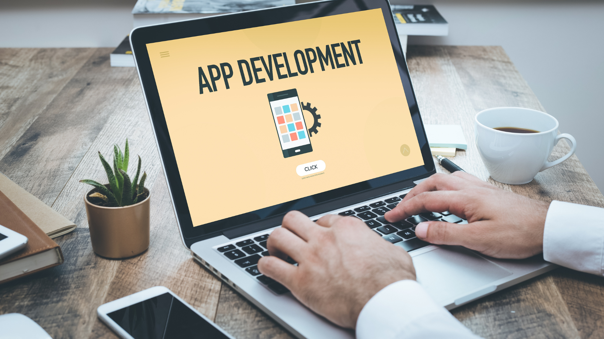 Person typing on a laptop displaying an 'App Development' screen, symbolizing software or mobile application development process.