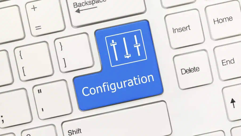 Close-up of a white keyboard with a blue key labeled “Configuration” featuring slider icons, representing software settings, customization, and system configuration.